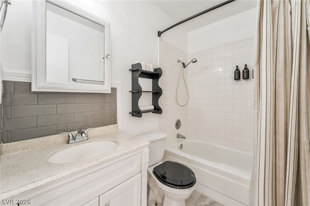 242 Nebraska Avenue Henderson, NV 89015 - Photo 42 of 46 Bathroom with backsplash, vanity, and shower / bath combo