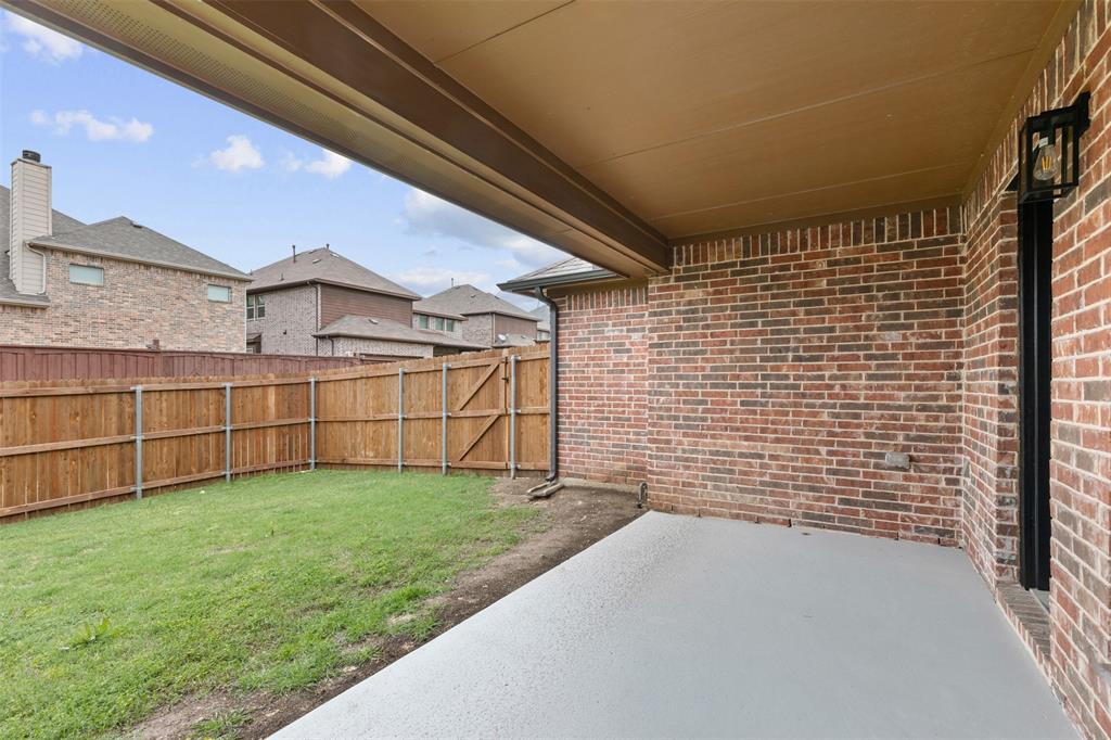 11984 Del Rio Drive Frisco, TX 75035 - Photo 37 of 38 View of yard featuring a patio, a fenced backyard, and a residential view