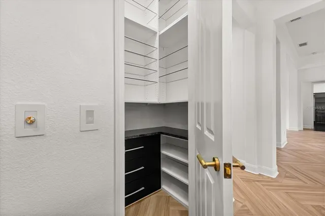 a living room with furniture a clock and a window