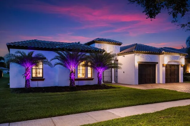 a backyard of a house with table and chairs