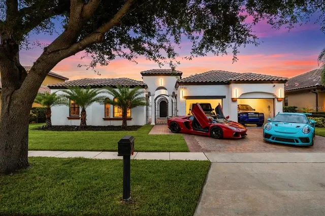 a backyard of a house with table and chairs