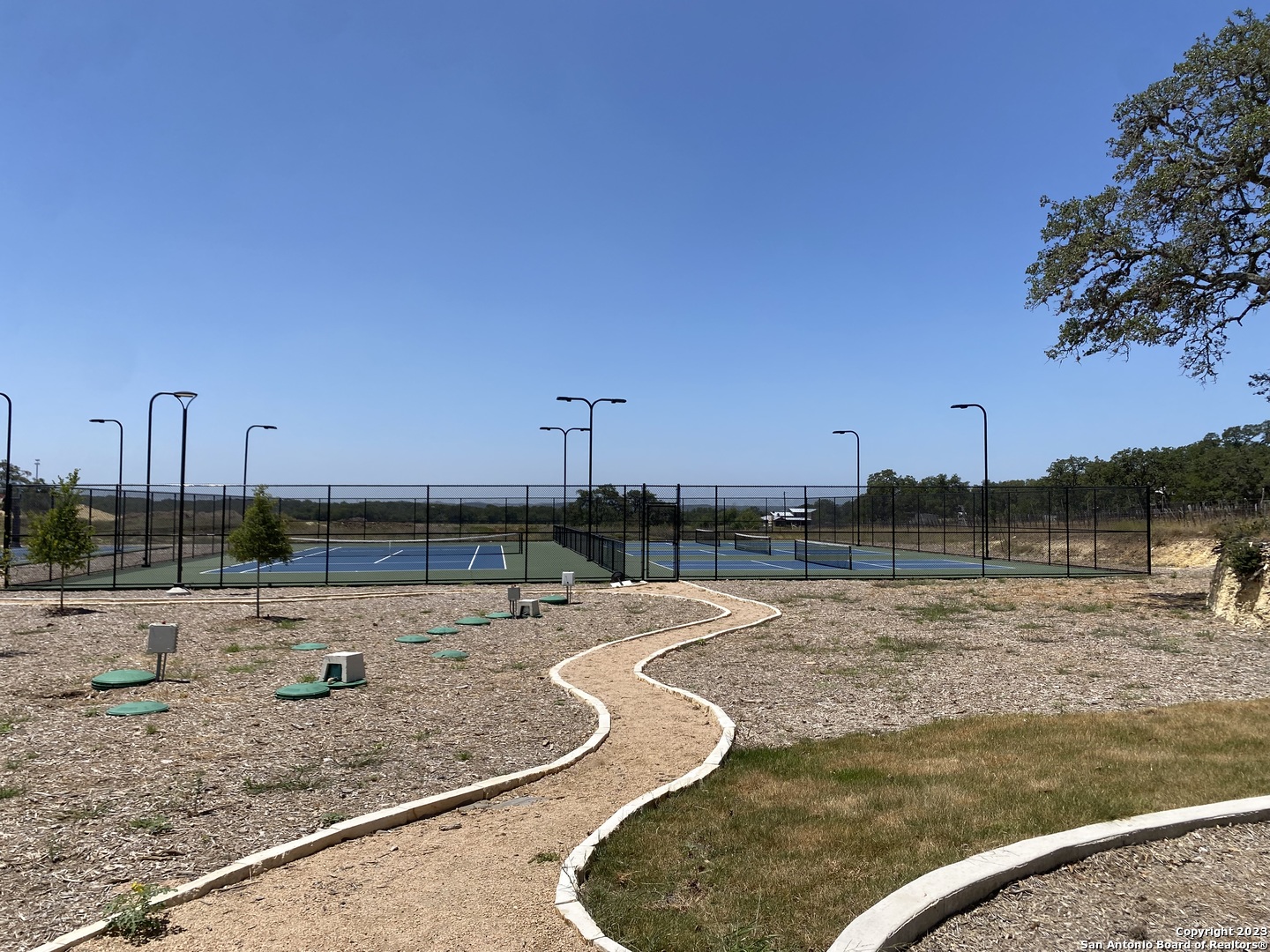 930 Maximino Ridge Rd. Bulverde, TX 78163 - Photo 14 of 18 a view of a swimming pool with a yard