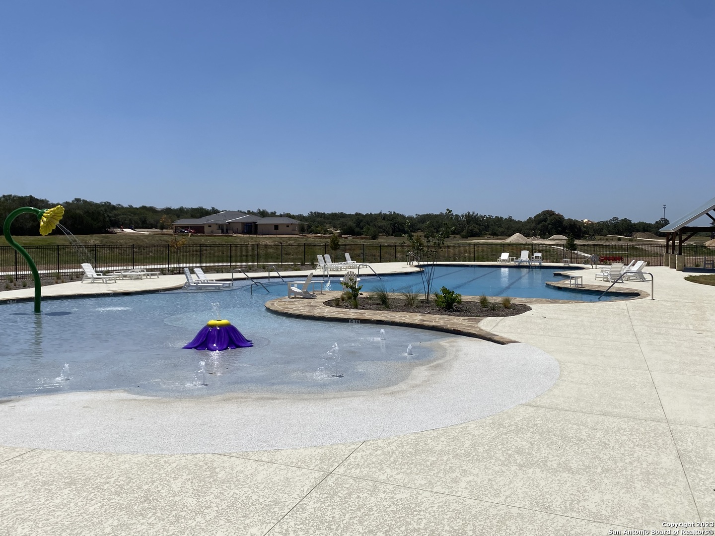 930 Maximino Ridge Rd. Bulverde, TX 78163 - Photo 10 of 18 a view of swimming pool with outdoor seating and a floor to ceiling window