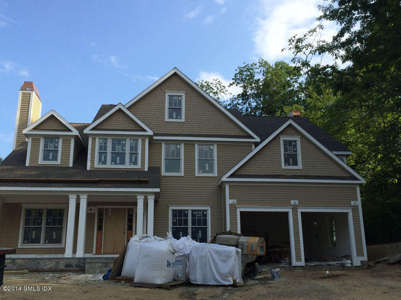 4 Gregory Road Cos Cob, CT 06807 - Photo 1 of 15 a front view of a house with a yard