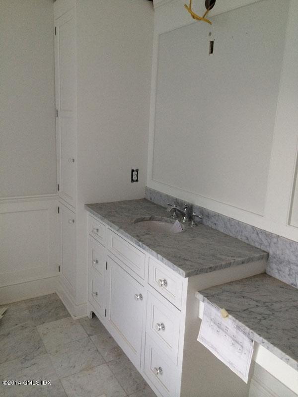 4 Gregory Road Cos Cob, CT 06807 - Photo 13 of 15 a bathroom with a granite countertop sink and white cabinets