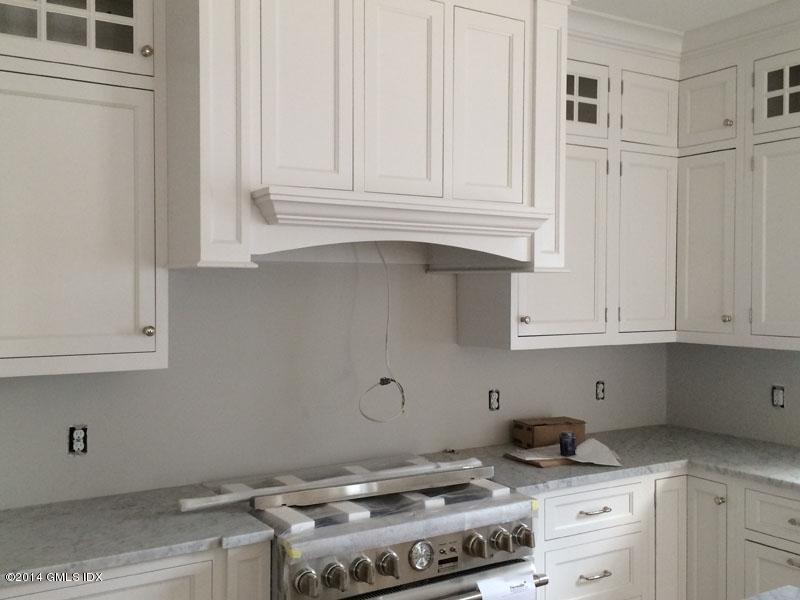 4 Gregory Road Cos Cob, CT 06807 - Photo 7 of 15 a kitchen with white cabinets and a stove