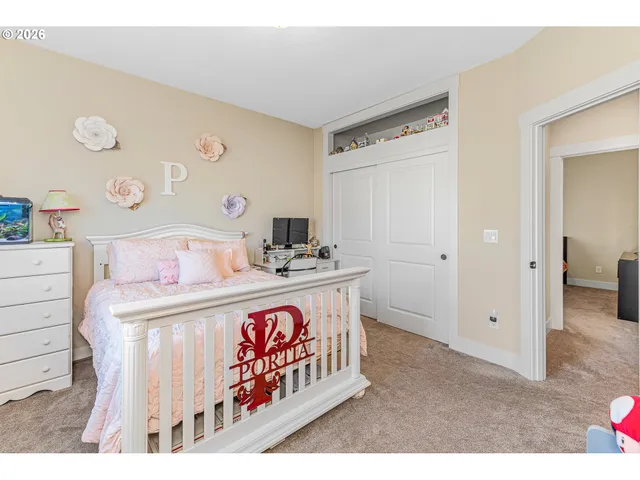 a spacious bedroom with a bed and a window