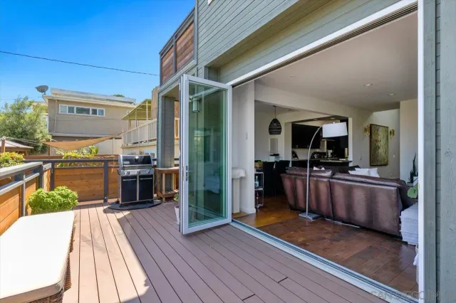 a view of a living room and kitchen outdoor space
