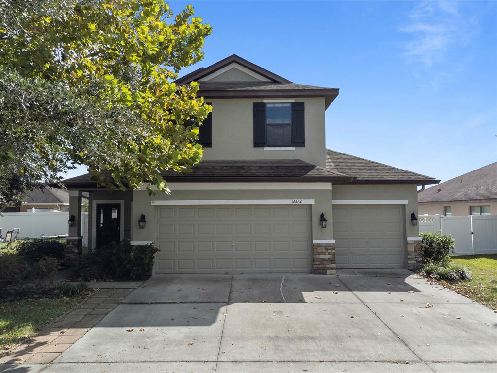 14404 Barley Field Drive Wimauma, FL 33598 - Photo 1 of 1 a front view of a house with a yard and garage