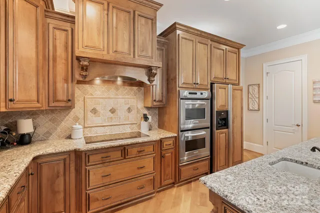 a kitchen with stainless steel appliances granite countertop a refrigerator and cabinets