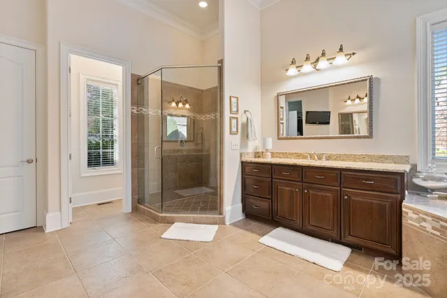 a spacious bathroom with a shower sink and mirror