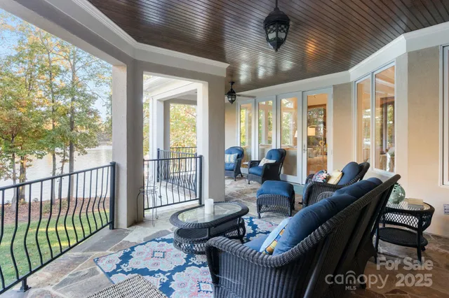 a living room with furniture and a floor to ceiling window