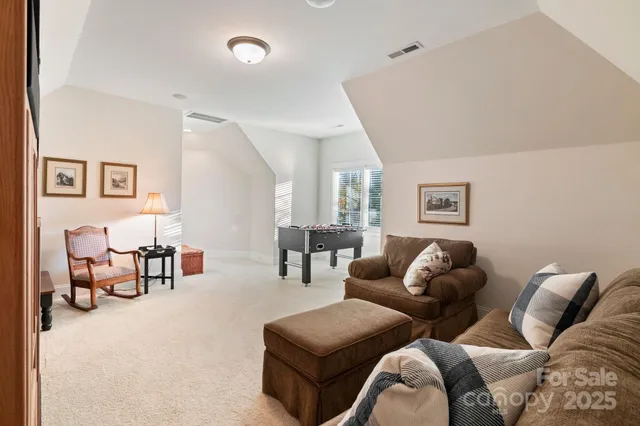 a living room with furniture and painting on the wall