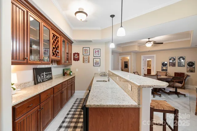 a large kitchen with kitchen island a large counter space a sink stainless steel appliances and cabinets