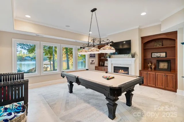 a living room with furniture a fireplace and a chandelier