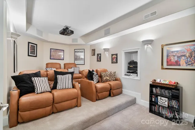 a living room with furniture a rug and a bookshelf