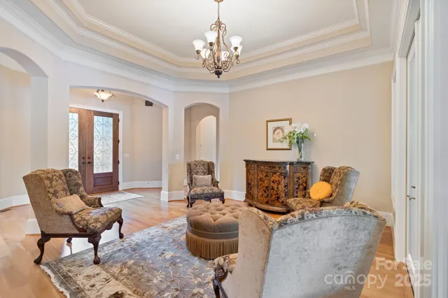 a living room with furniture and a chandelier
