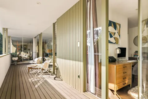 a balcony with furniture and a potted plant
