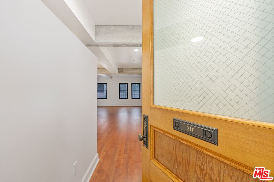 416 South Spring Street, Unit 210 Los Angeles, CA 90013 - Photo 13 of 18 a view of a room with wooden floor
