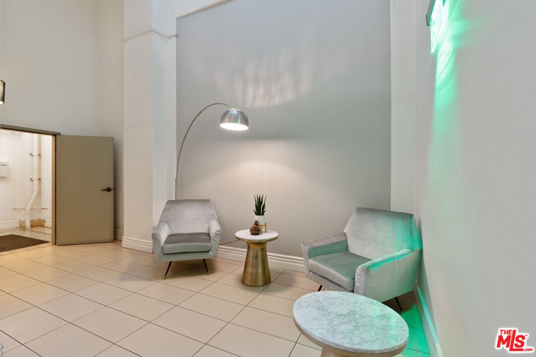 416 South Spring Street, Unit 210 Los Angeles, CA 90013 - Photo 14 of 18 a living room with furniture and a lamp