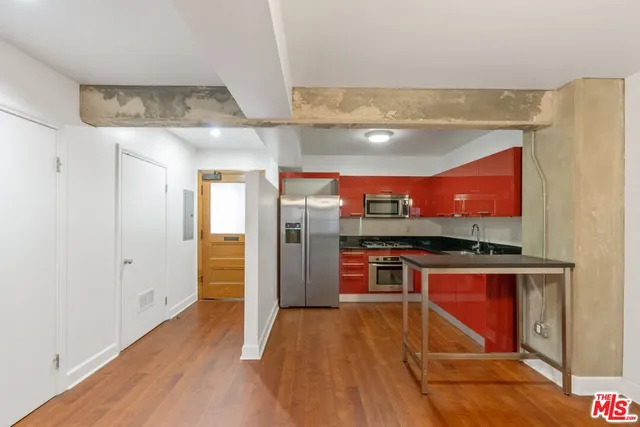 a kitchen with stainless steel appliances granite countertop a refrigerator and a sink