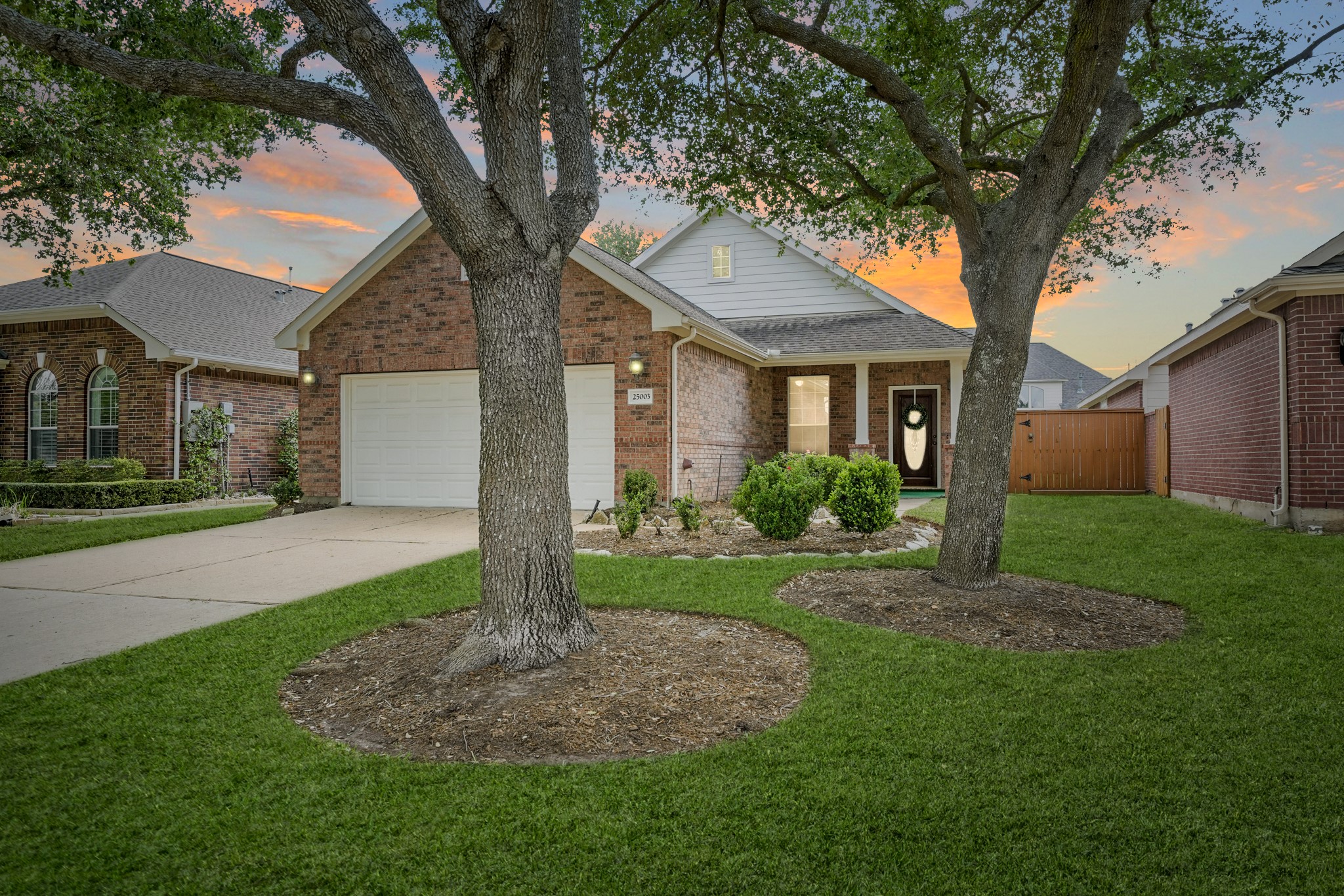 25003 Spring Ash Lane Katy, TX 77494 - Photo 43 of 43 Nestled on a serene, tree-lined street in the vibrant 55+ gated community of Heritage Grand, this charming Longwood floorplan boasts a brick and wood exterior, surrounded by mature trees that offer a natural canopy of shade, ideally located in the heart of Cinco Ranch. The front yard of the home is mowed, fertilized, mulched, bushes pruned and insect treated on a regular schedule included in the HOA along with maintaining the sprinkler system.