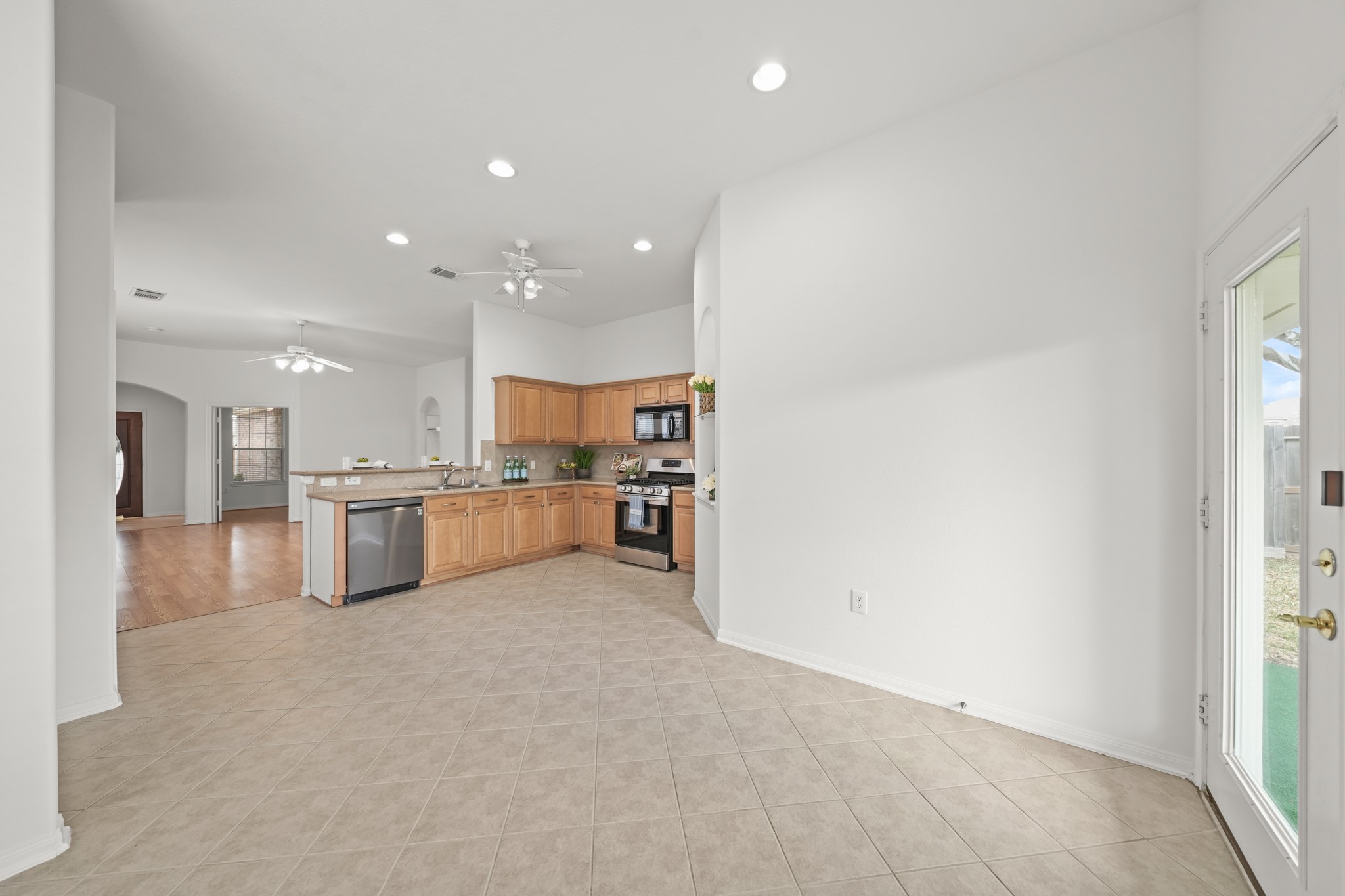 25003 Spring Ash Lane Katy, TX 77494 - Photo 13 of 43 Experience seamless living with this open-concept kitchen and dining area, perfect for effortless meals, lively conversation and warm gatherings.