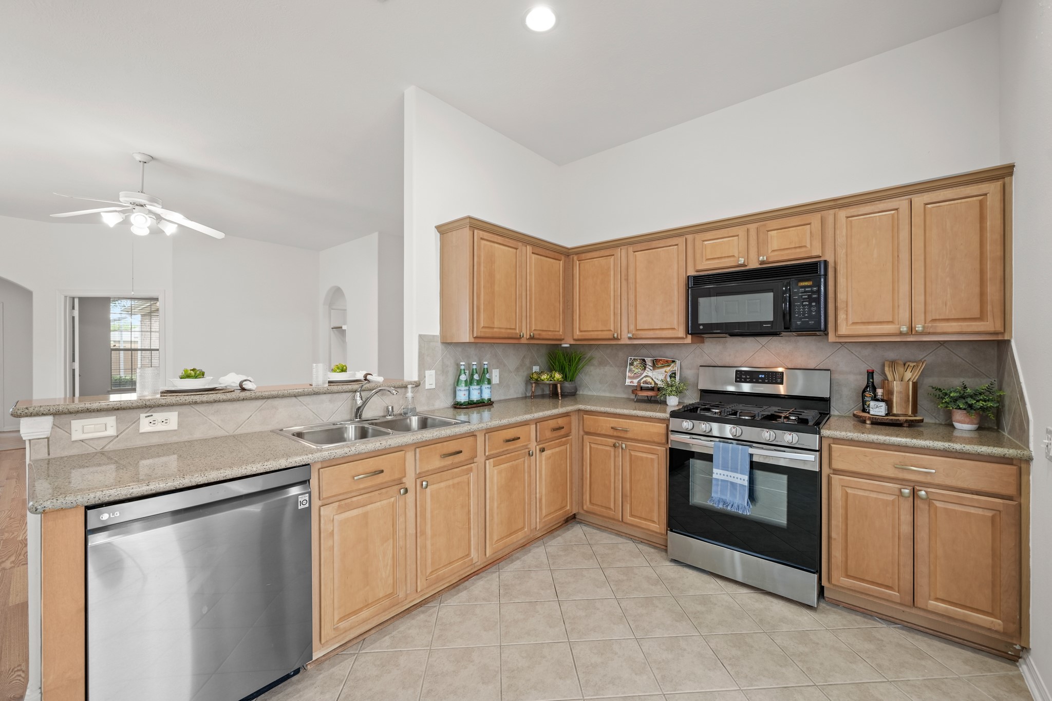 25003 Spring Ash Lane Katy, TX 77494 - Photo 16 of 43 This kitchen features a stainless steel Samsung five-burner gas range and oven, a GE microwave and an LG dishwasher, all elegantly integrated with plenty of counters space for meal preparation.