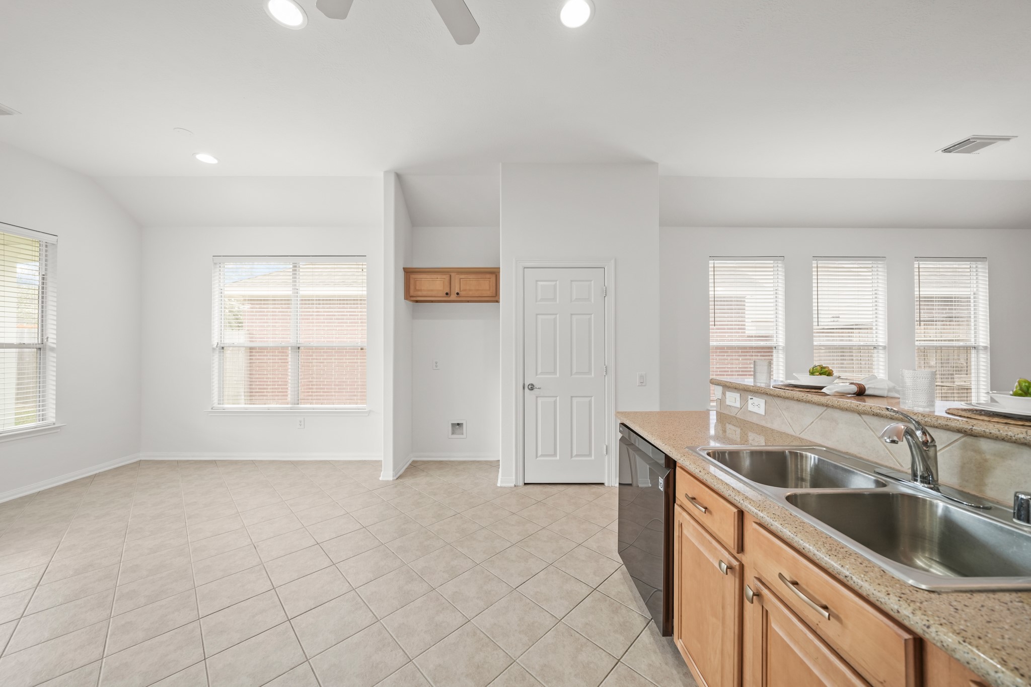 25003 Spring Ash Lane Katy, TX 77494 - Photo 17 of 43 The dining area and kitchen seamlessly connects to the family room, offering a perfect blend of space for lively gatherings and peaceful retreats.