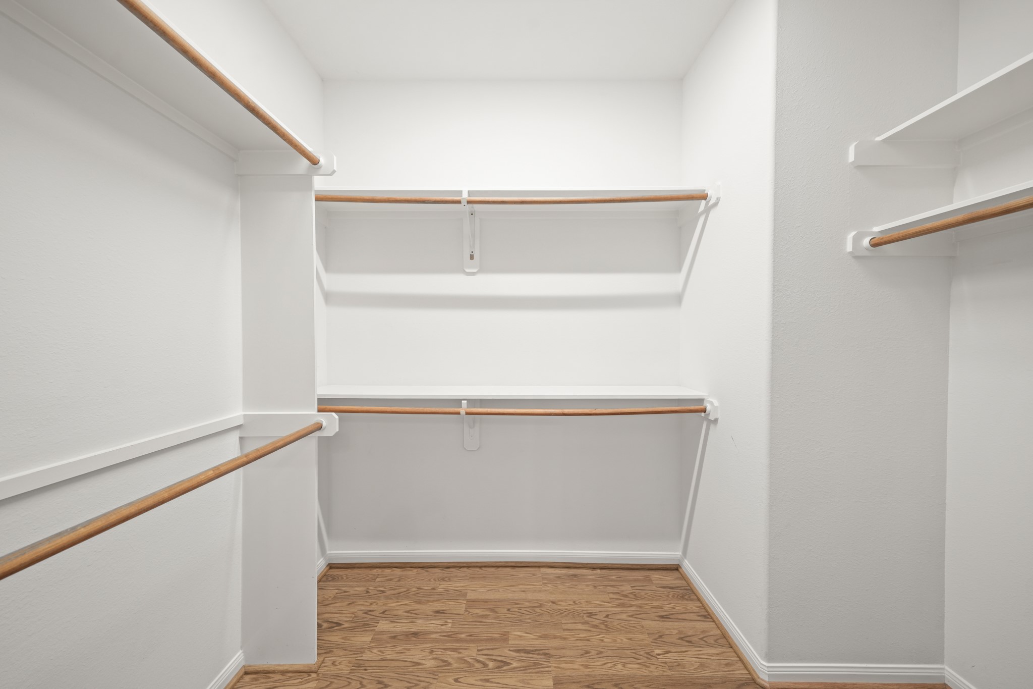 25003 Spring Ash Lane Katy, TX 77494 - Photo 20 of 43 Discover the luxury and comfort of a spacious walk-in closet with dual shelving rods, elegantly tucked inside the primary suite.