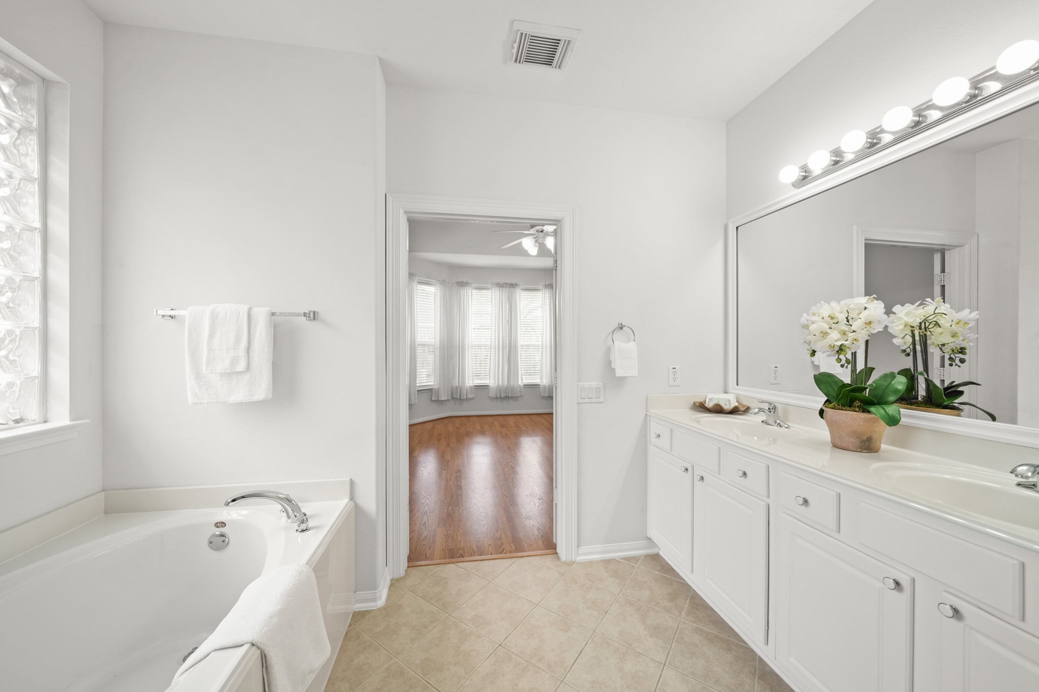 25003 Spring Ash Lane Katy, TX 77494 - Photo 25 of 43 Elegant double doors seamlessly connect the primary suite to the luxurious bath, creating a serene retreat-like flow.