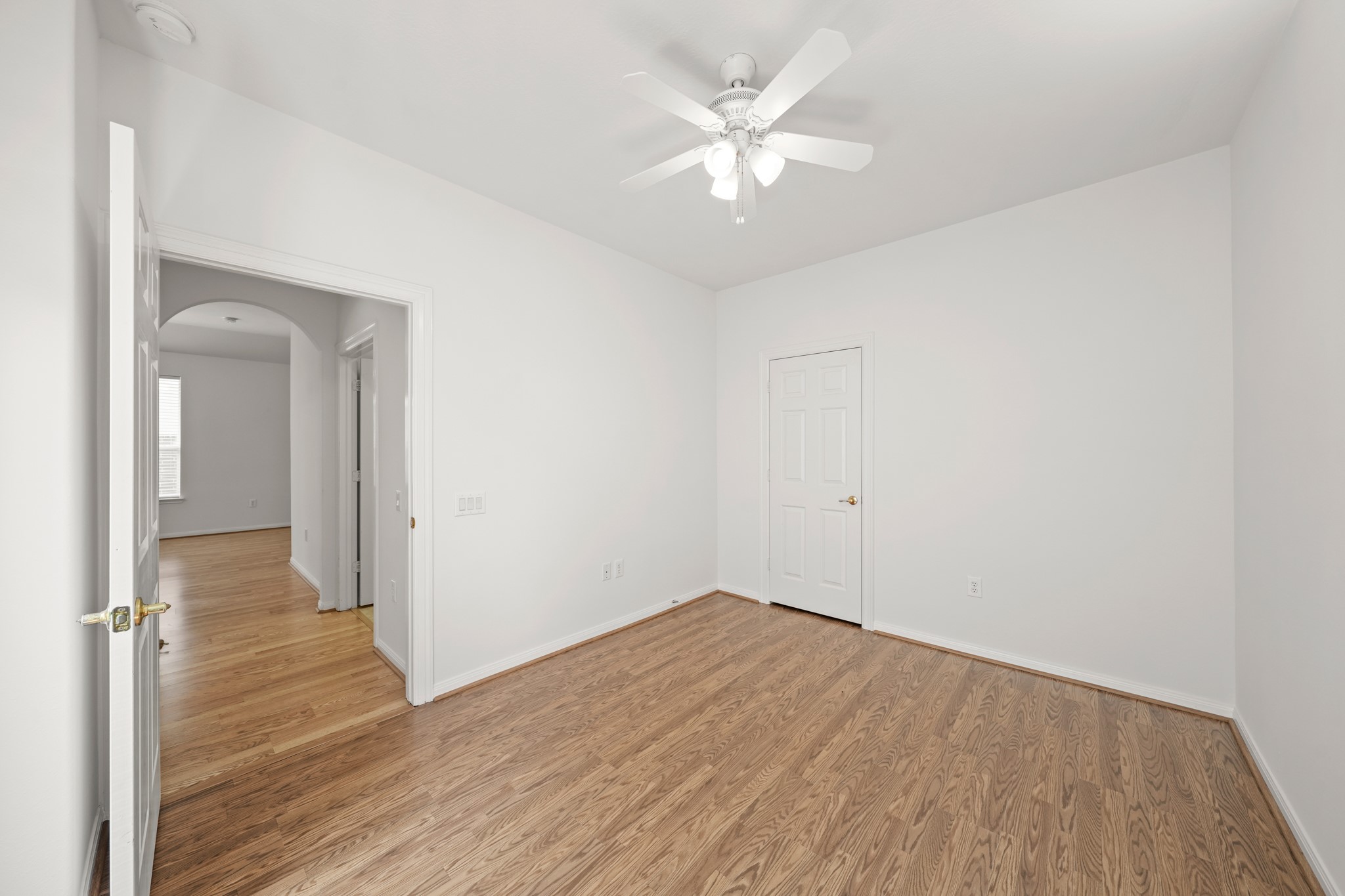 25003 Spring Ash Lane Katy, TX 77494 - Photo 27 of 43 Discover the inviting charm of the secondary bedroom, featuring a seamless flow through its doorway into the welcoming hallway with access to a second full bath and laundry room.