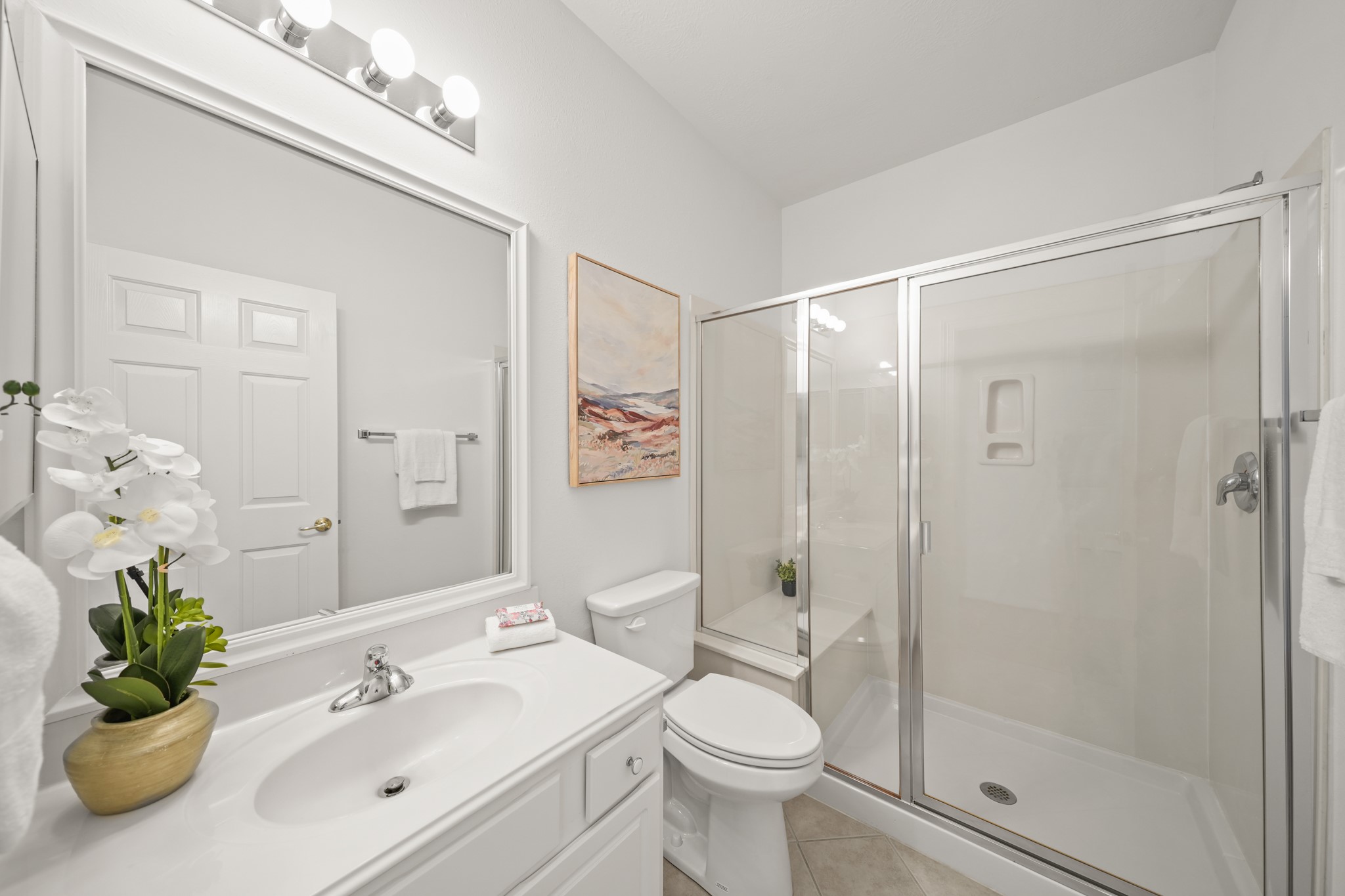 25003 Spring Ash Lane Katy, TX 77494 - Photo 31 of 43 Experience daily luxury in the second full bath, featuring elegant tile floors, a cultured marble sink and a spacious walk-in shower with a seated bench for ultimate comfort and convenience.