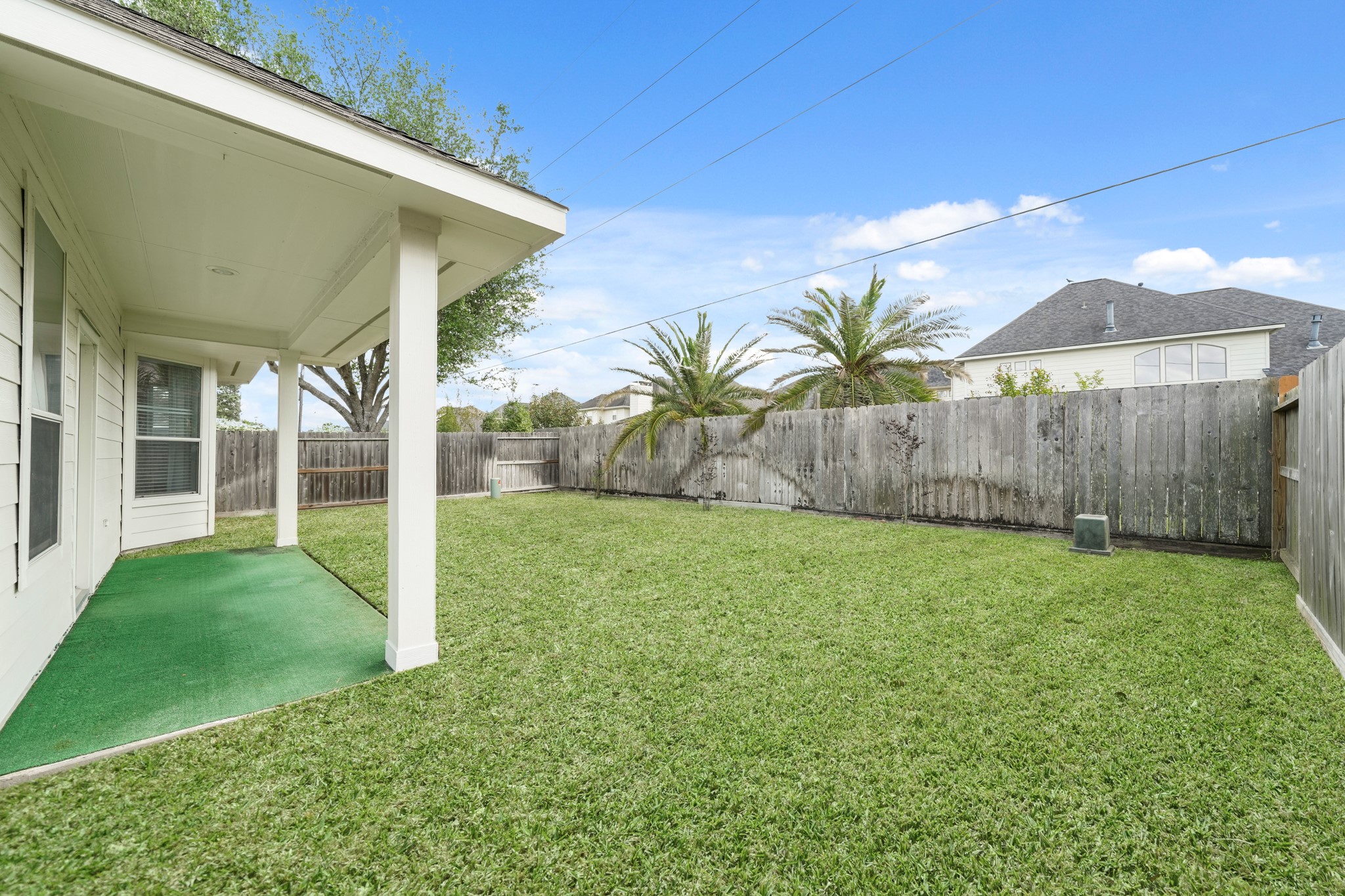 25003 Spring Ash Lane Katy, TX 77494 - Photo 34 of 43 Discover serenity on the back covered patio, the perfect spot to savor your morning coffee amidst fresh air and tranquility before the day unfolds. The home also has a whole home surge protector, fresh paint throughout, a two year old heater, five year old A/C and so much more!