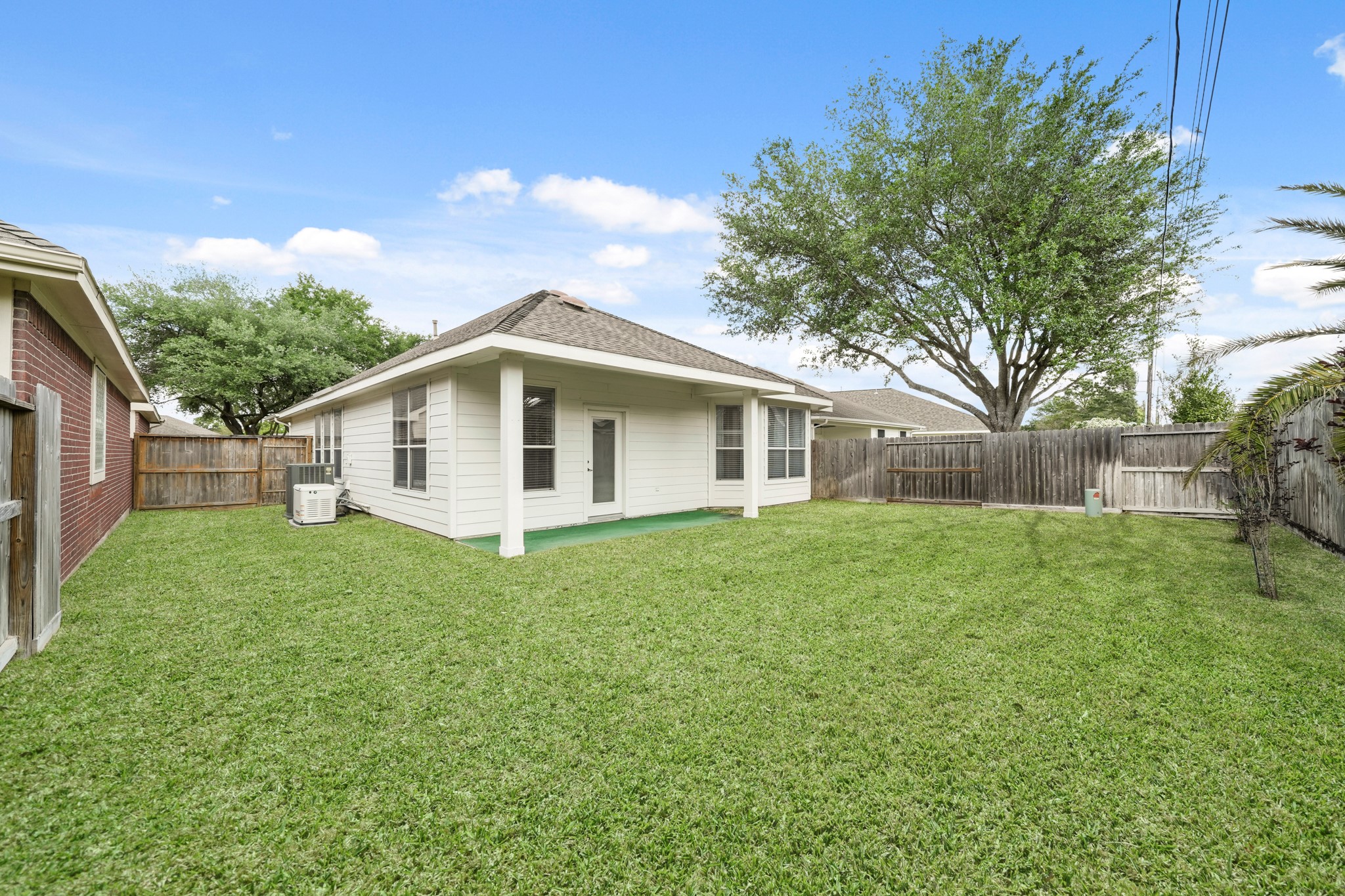 25003 Spring Ash Lane Katy, TX 77494 - Photo 35 of 43 This backyard offers a perfect blend of relaxation and entertainment, with its open lawn and inviting atmosphere ideal for casual hangouts and weekend cookouts.