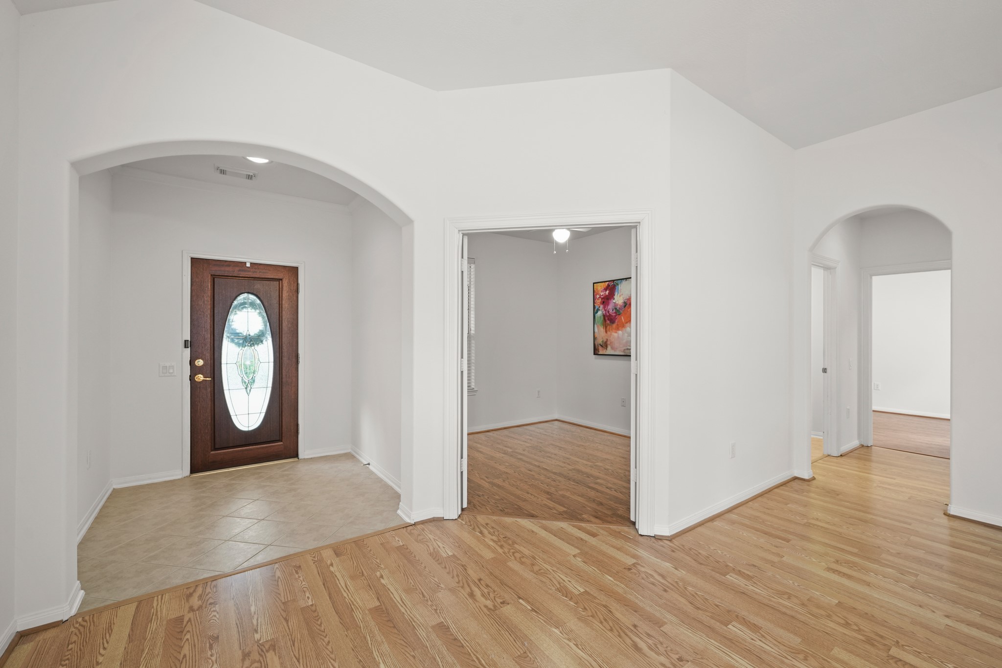 25003 Spring Ash Lane Katy, TX 77494 - Photo 3 of 43 A view of the entry, where elegant curved archways gracefully guide you to a central study with the convenience of a secondary bedroom just steps to the right.