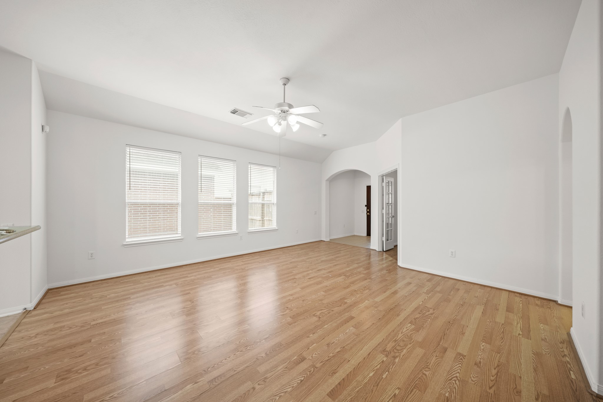 25003 Spring Ash Lane Katy, TX 77494 - Photo 7 of 43 This inviting family room is designed for connection, offering ample space for entertaining and beautifully enhanced by soft natural light that creates a bright and welcoming atmosphere.