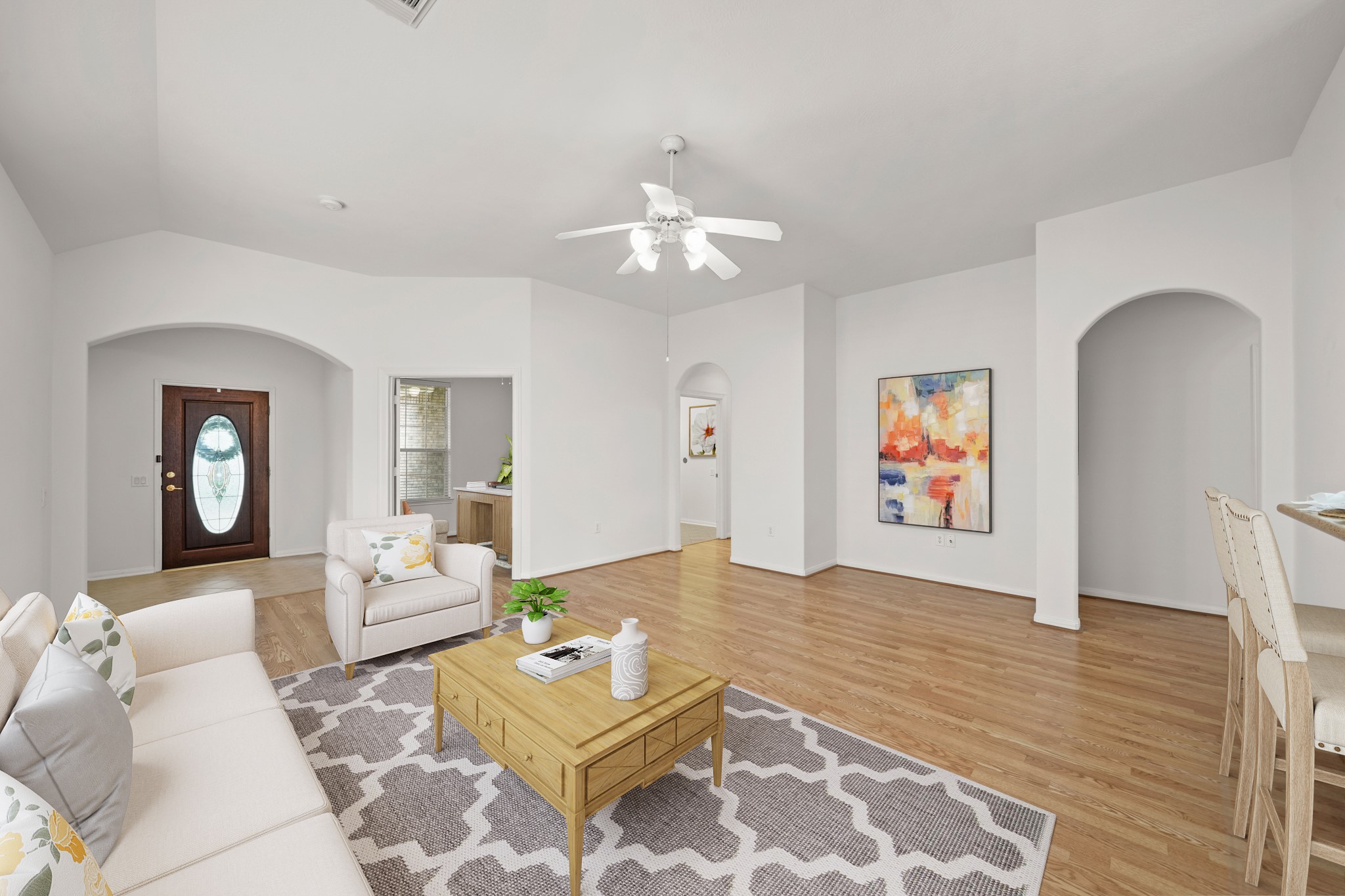 25003 Spring Ash Lane Katy, TX 77494 - Photo 8 of 43 Perfectly situated as the heart of the home, the family room seamlessly connects to the front entry, the private study and the nearby secondary bedroom, offering a versatile layout ideal for hosting, working and everyday comfort. Notice all of the gorgeous archways throughout. This picture has been virtually staged.