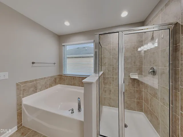 a bathroom with a tub and shower