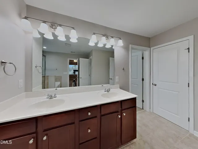 a bathroom with a sink double vanity and a mirror