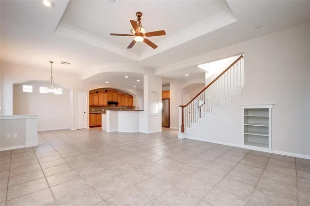 a view of a livingroom with a ceiling fan and entryway