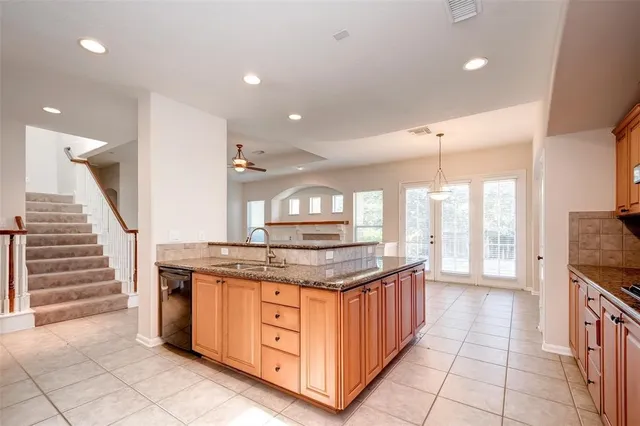a kitchen with stainless steel appliances granite countertop a stove and a sink