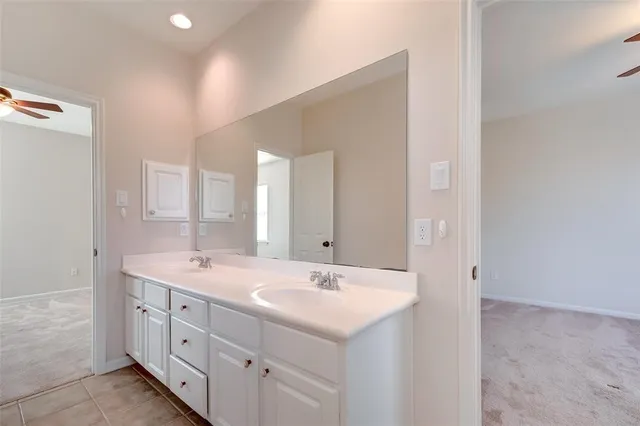 a bathroom with double sink and a mirror
