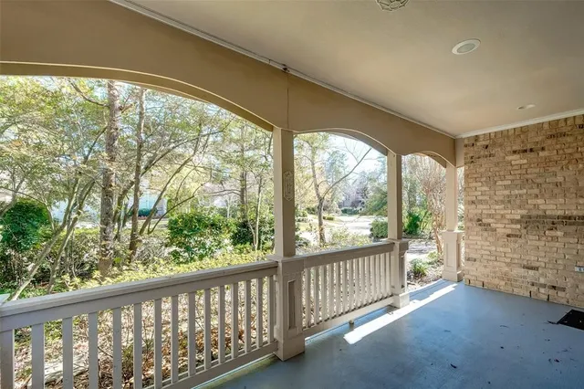 a view of a porch with a floor to ceiling window and wooden floor