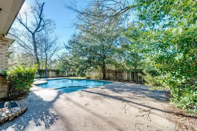a view of backyard with large trees