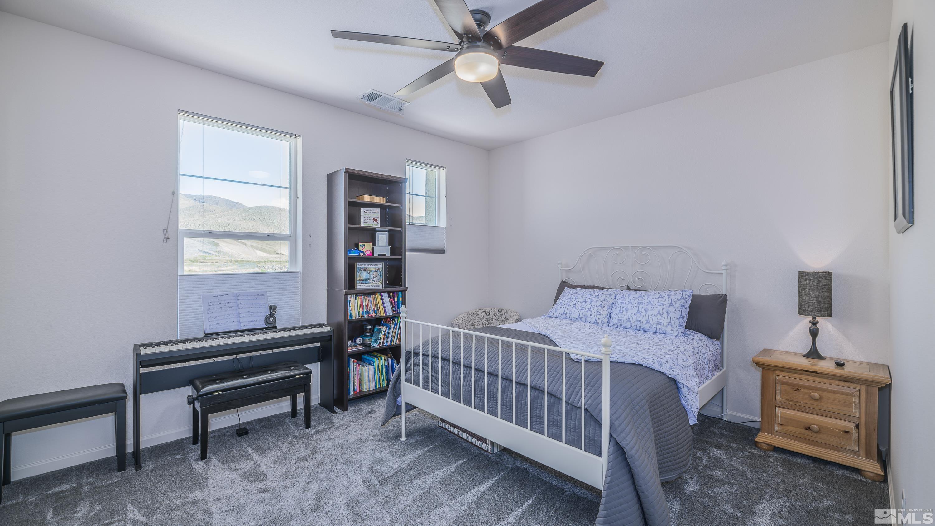 9269 Canvas Edge Lane Reno, NV 89521 - Photo 27 of 39 a bedroom with a bed and a window
