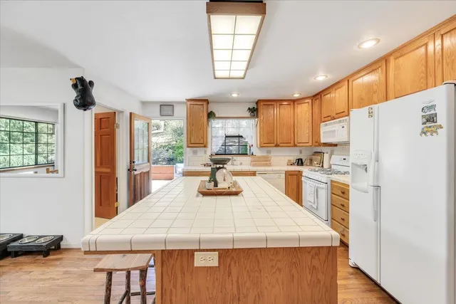 a view of entryway with furniture and wooden floor