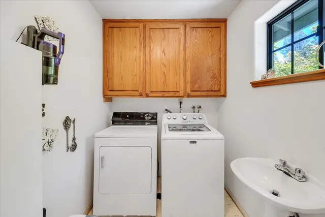 a bathroom with a sink and mirror with window