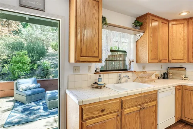a view of a house with a yard and wooden deck