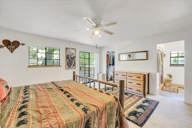 an aerial view of a house with a yard and large tree